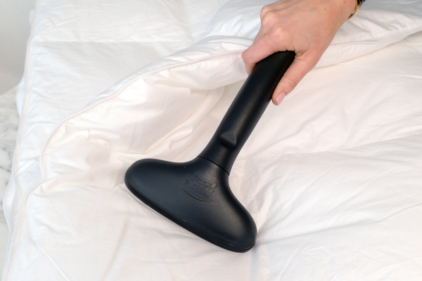 4881_one_size_image_01_7858_-36001679 Woman steaming bed sheets