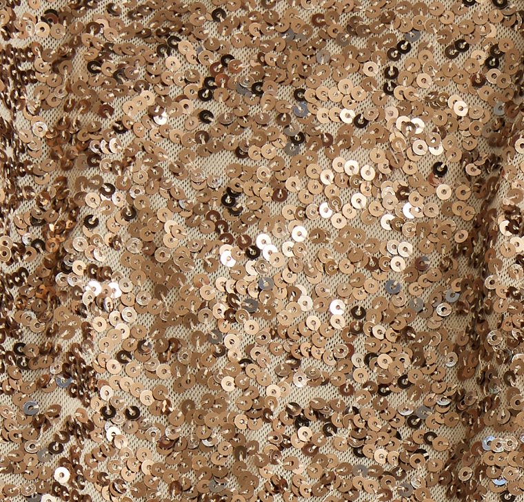 Glistening sequined fabric as part of the washing process A close-up of gold sequined fabric, prepared for washing.